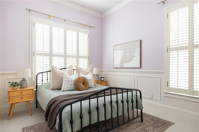 461 Bartram St SE Unit A, Atlanta, GA 30316 - bedroom featuring multiple windows, carpet floors, wainscoting, crown molding, and a decorative wall