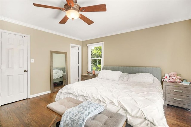 bedroom featuring crown molding, baseboards, and wood finished floors