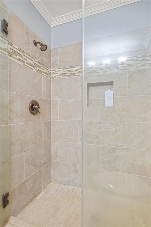 full bath featuring a stall shower and crown molding