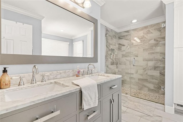 full bath with double vanity, a shower stall, crown molding, and a sink