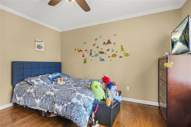 bedroom featuring crown molding, baseboards, and wood finished floors