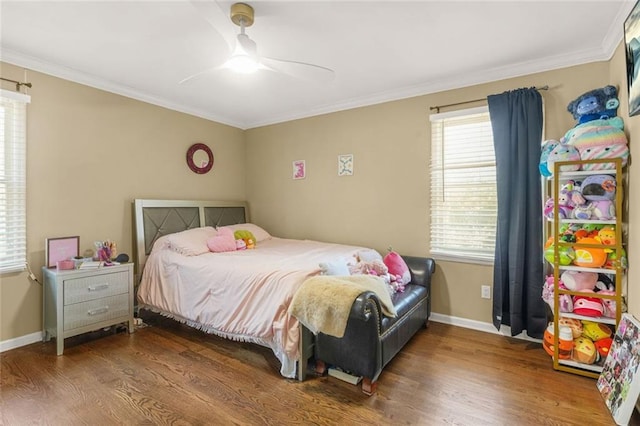 bedroom with ceiling fan, baseboards, wood finished floors, and crown molding