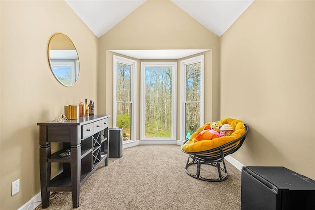 sitting room featuring baseboards, carpet, and vaulted ceiling