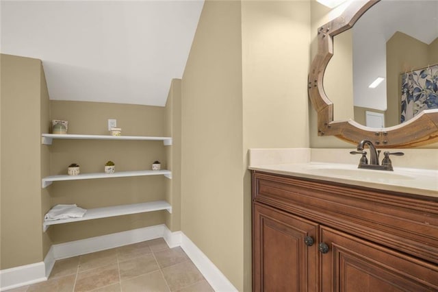 bathroom featuring vanity, baseboards, and tile patterned flooring