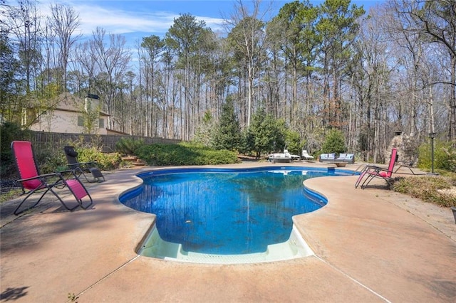 view of pool featuring a fenced in pool, fence, and a patio area