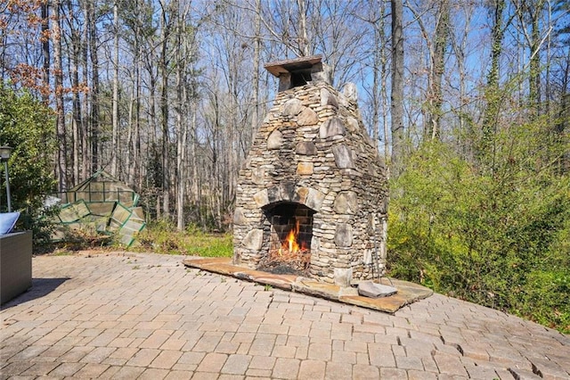 view of patio / terrace with an outdoor stone fireplace