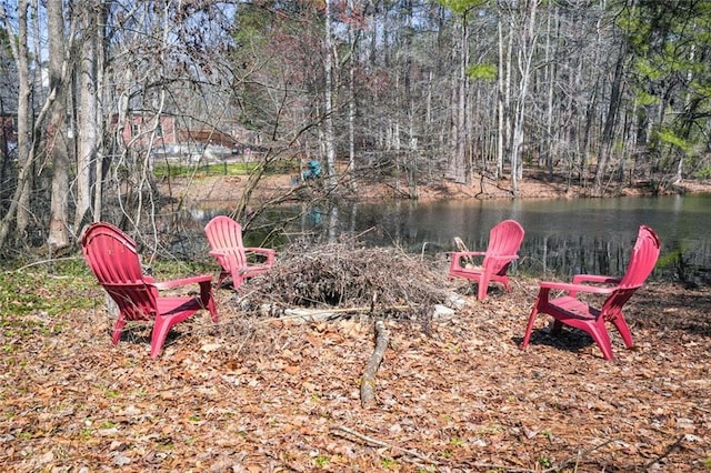 view of yard with a view of trees and a water view