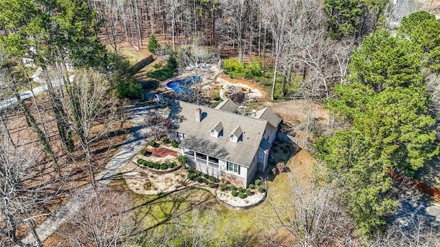 birds eye view of property with a forest view