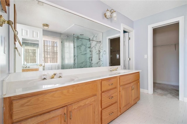 bathroom with an enclosed shower, vanity, and tile patterned flooring