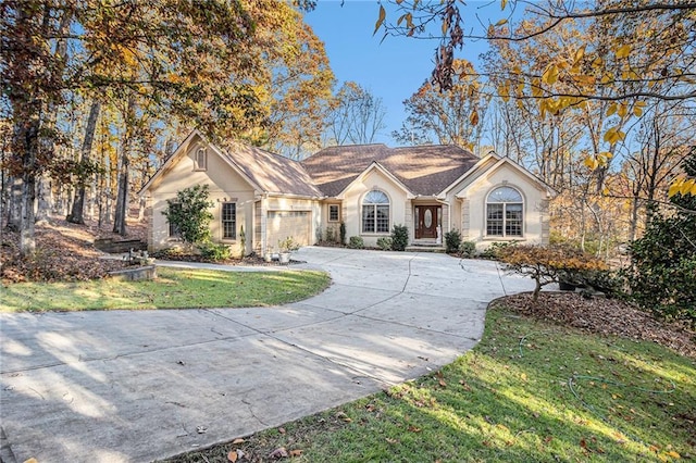 single story home with a front yard and a garage