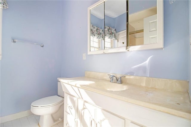 bathroom featuring tile patterned floors, vanity, and toilet