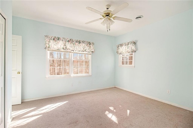 empty room with ceiling fan and carpet