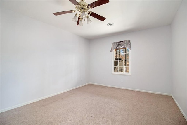 empty room featuring ceiling fan and carpet