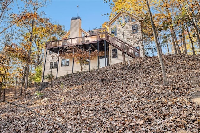 rear view of property featuring a wooden deck