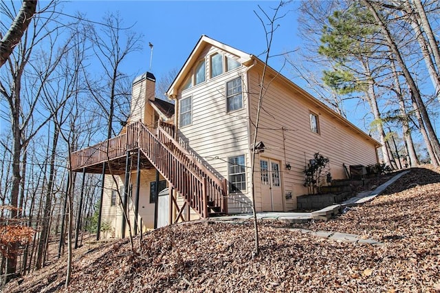 rear view of property with a wooden deck