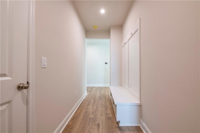 corridor with light hardwood / wood-style flooring