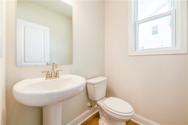 bathroom with toilet and hardwood / wood-style flooring