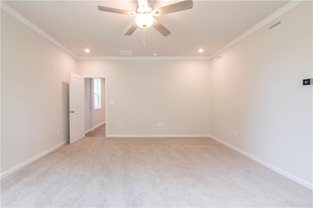 carpeted empty room featuring ceiling fan and ornamental molding