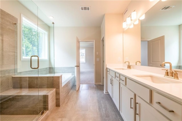 bathroom with vanity, independent shower and bath, and tile patterned flooring