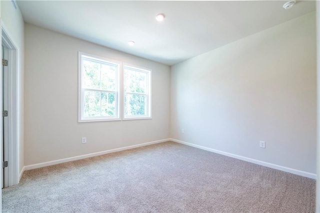 unfurnished room with light colored carpet