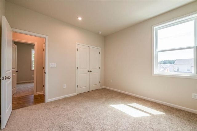 unfurnished bedroom with carpet floors and a closet