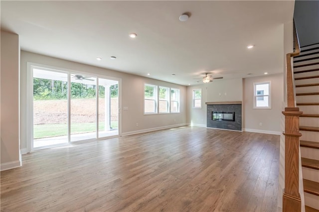 unfurnished living room featuring light hardwood / wood-style flooring and ceiling fan