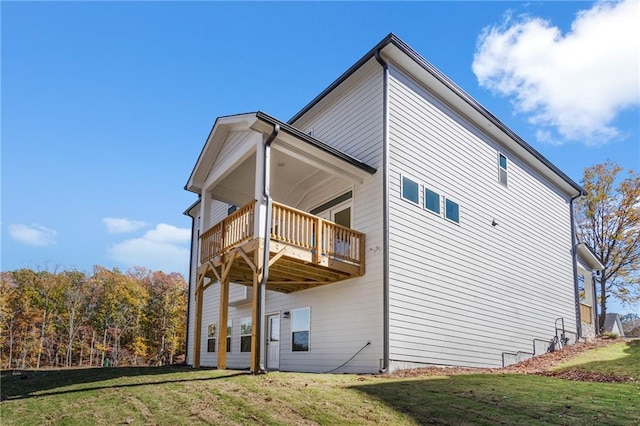 view of side of home with a lawn and a wooden deck