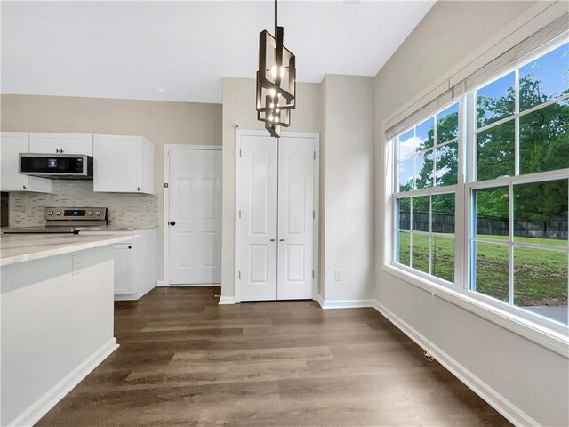 617 Kyles Cir, Hiram, GA 30141 - unfurnished living room featuring dark wood-type flooring, ceiling fan, baseboards, and a fireplace