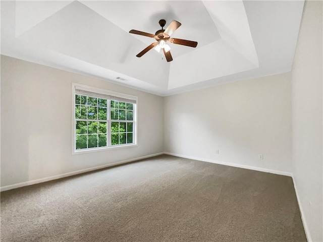 617 Kyles Cir, Hiram, GA 30141 - empty room featuring a raised ceiling, dark carpet, ceiling fan, and baseboards