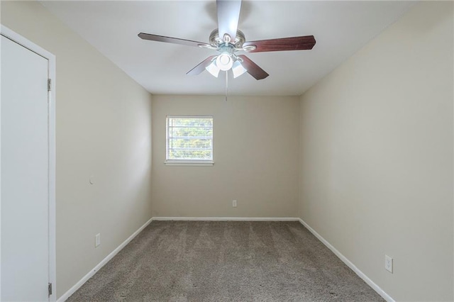 carpeted spare room with ceiling fan