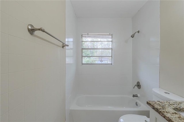 full bathroom with tiled shower / bath combo, vanity, and toilet