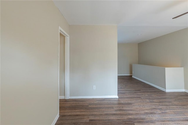 spare room featuring ceiling fan and dark wood-type flooring