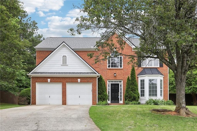 view of front of property with a garage, driveway, brick siding, and a front yard