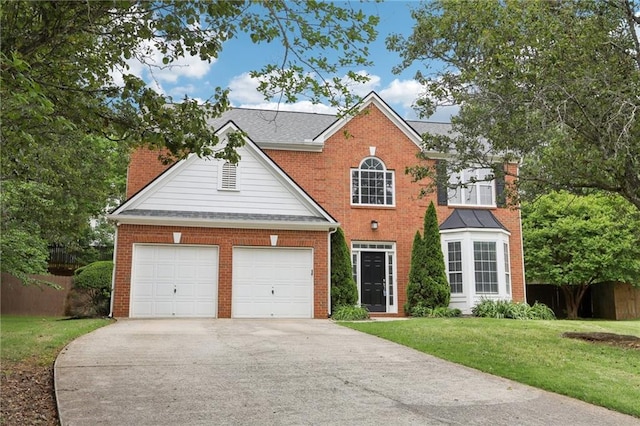 view of front of property with brick siding, fence, a front yard, and concrete driveway
