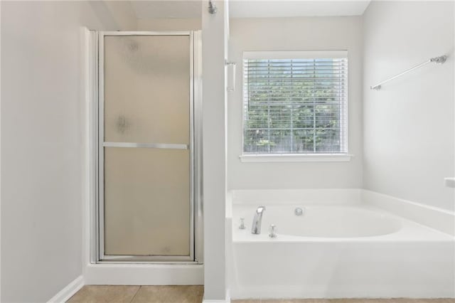 full bathroom with a garden tub, tile patterned flooring, and a shower stall