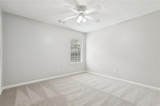 unfurnished room featuring carpet floors, baseboards, and visible vents