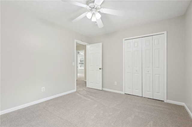 unfurnished bedroom featuring carpet flooring, baseboards, ceiling fan, and a closet