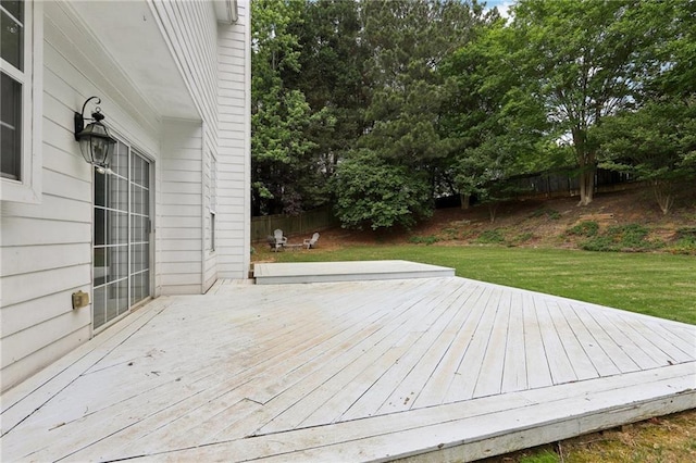 wooden deck featuring a yard and fence