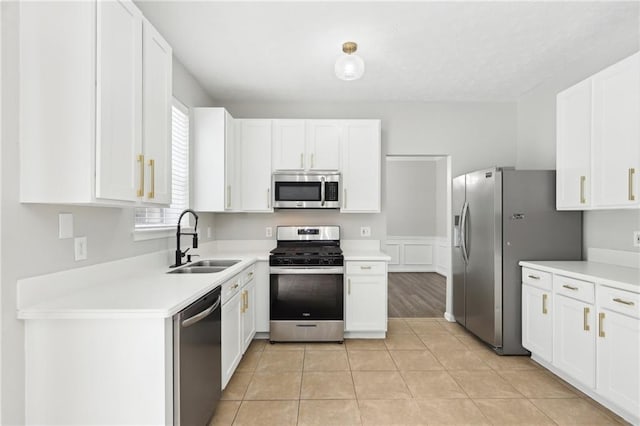 kitchen featuring white cabinets, appliances with stainless steel finishes, and a sink