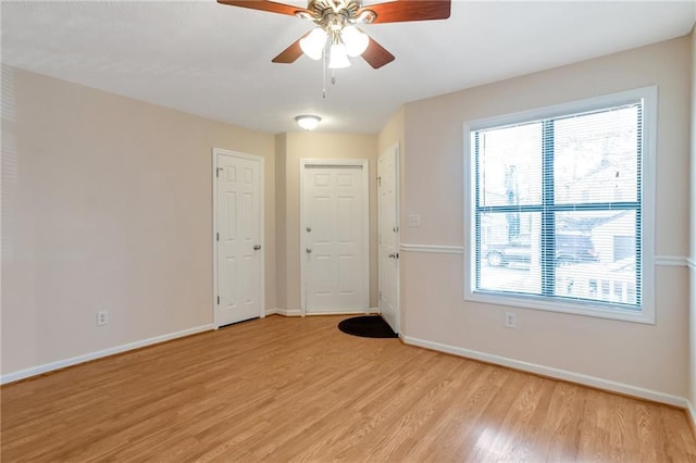 empty room featuring ceiling fan and light hardwood / wood-style flooring