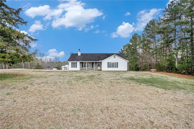 rear view of house with a lawn and a chimney