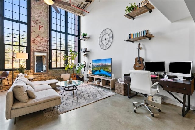 office featuring concrete floors and a towering ceiling