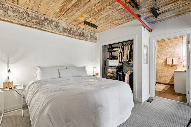 bedroom featuring a closet, light colored carpet, and wooden ceiling