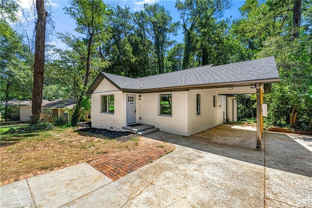 single story home featuring a carport