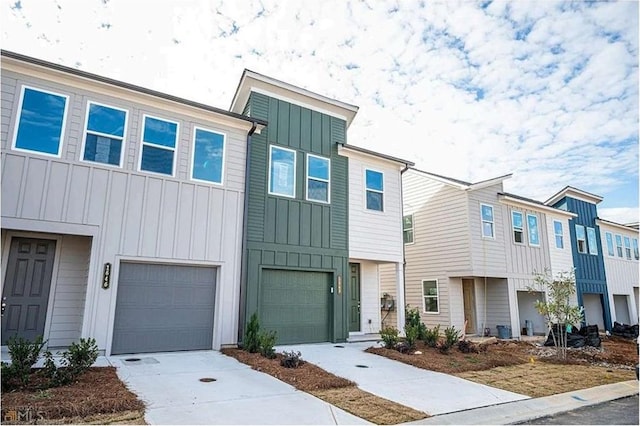 1648 Florence Run NW, Atlanta, GA 30318 - townhome / multi-family property with board and batten siding, an attached garage, and driveway