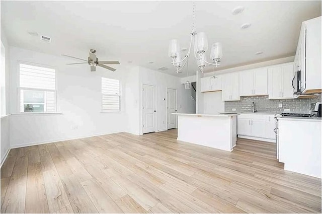 1648 Florence Run NW, Atlanta, GA 30318 - kitchen featuring a center island, a ceiling fan, open floor plan, and a chandelier