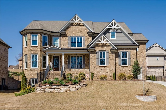 craftsman-style home featuring brick siding and fence