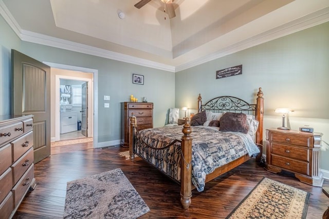 bedroom with baseboards, ornamental molding, a tray ceiling, and dark wood-style flooring