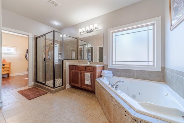 full bath with visible vents, a shower stall, a wealth of natural light, and vanity