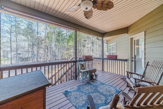 sunroom featuring a ceiling fan and a healthy amount of sunlight